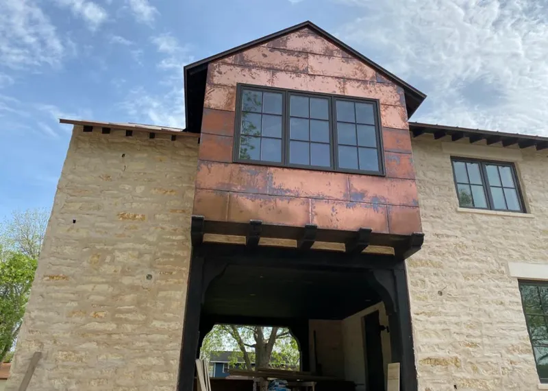 Copper metal panel facade on a stone building for Skylight Installation in Bolingbrook