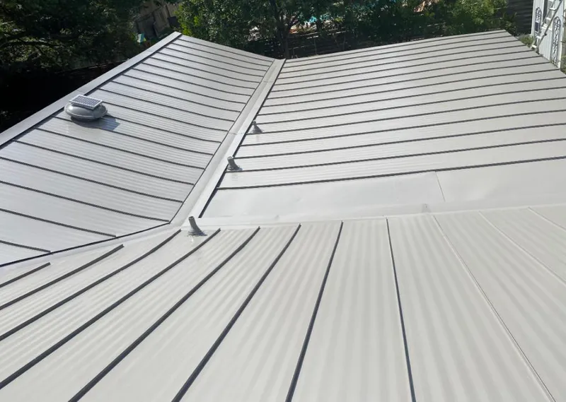 Solar attic fan installed on a metal roof for Roof Ventilation in Bolingbrook